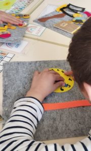 Un enfant manipule une illustration d'horloge